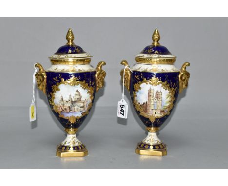 TWO COALPORT TWIN HANDLED VASES AND COVERS, blue, gilt and pale yellow ground, one with a hand painted vignette of Westminste