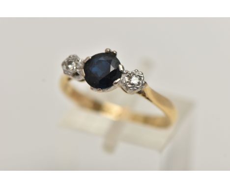 AN 18CT GOLD SAPPHIRE AND DIAMOND RING, a circular cut blue sapphire, set with two illusion set round brilliant cut diamonds,