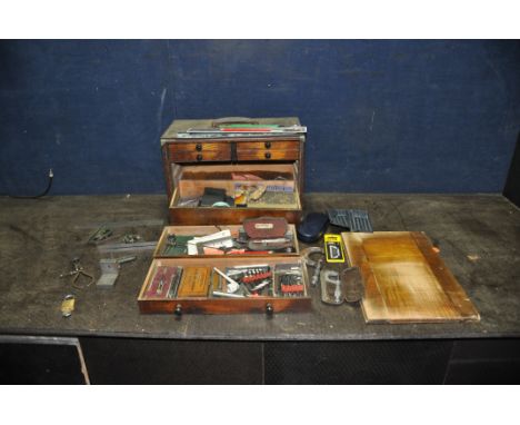 A VINTAGE WOODEN ENGINEERS TOOLS CABINET with lid off front concealing four short of three long drawers all containing test e