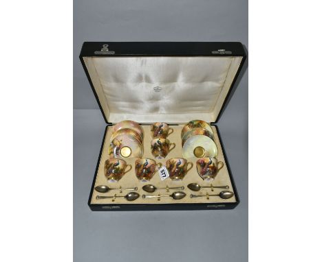 A CASED SET OF SIX ROYAL WORCESTER COFFEE CUPS AND SAUCERS AND SIX SILVER GILT COFFEE SPOONS, the cups with gilt interiors ha