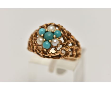 A YELLOW METAL GEMSET DOME RING, a textured open work ring, cluster set with three split pearls and four turquoise stones, un