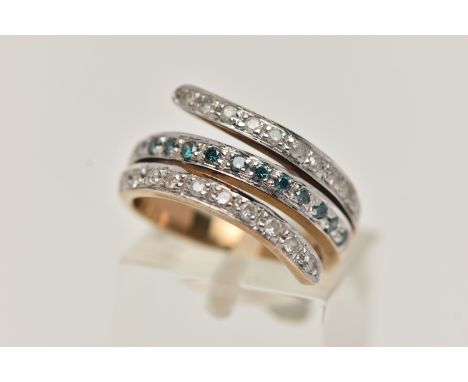A 9CT GOLD DIAMOND RING, cross over design with a central row of treated blue diamonds, between two rows of brilliant cut dia