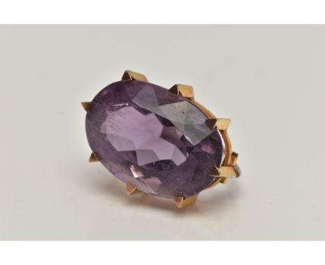 A YELLOW METAL AMETHYST BROOCH, large oval cut amethyst in an eight claw setting, amethyst measuring approximately length 27.