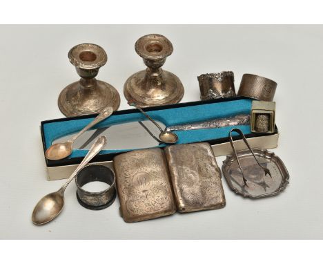 A BOX OF ASSORTED SILVER AND WHITE METAL, to include two napkin rings, a cigarette case, two tea spoons, small ice tongs, a c