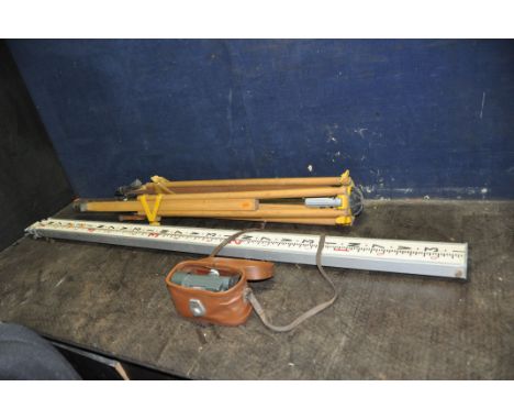A SURVEYORS LEVEL IN LEATHER EFFECT CASE along with a tripos and measure (3)