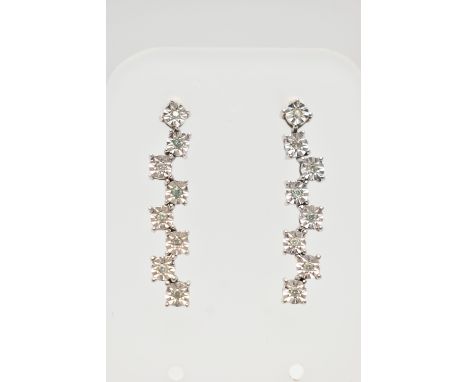 A PAIR OF 9CT WHITE GOLD DIAMOND DROP EARRINGS, each earring set with a row of illusion set round brilliant cut diamonds, est