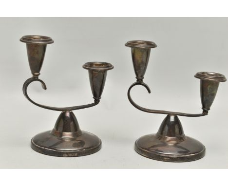 A PAIR OF ELKINGTON & CO SILVER CANDLE STICKS, each on a round weighted base, with scroll detail set with two candle holders,