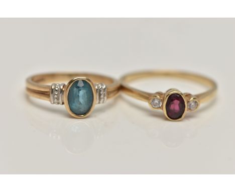 TWO 9CT GOLD GEM SET RINGS, the first set with an oval cut blue topaz, collet set to a white metal shoulder and yellow metal 