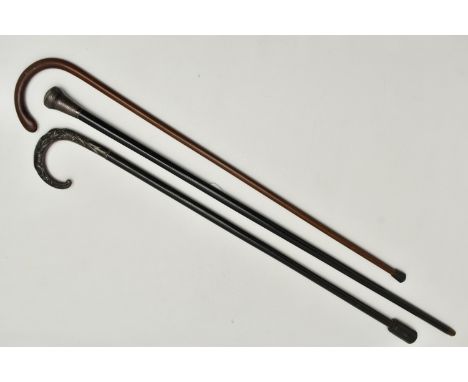 A COLLECTION OF THREE WALKING STICKS, the first an ebonised stick, fitted with a silver pommel, hallmarked London 1923, toget