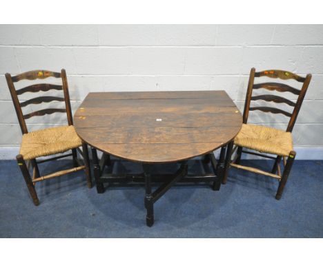 A GEORGIAN OAK GATE LEG TABLE, width 114cm x depth 49cm x height 72cm, and two rush seated ladderback chairs (condition repor