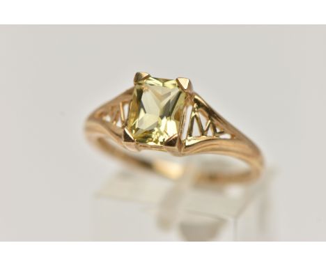 A 9CT GOLD CITRINE RING, yellow gold, set with a rectangular cut citrine, four claw set to the open work shoulders and polish