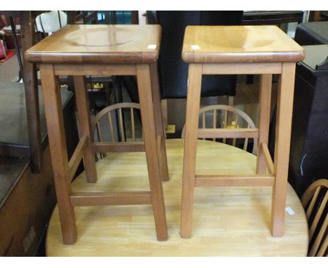 A pair of beechwood bar stools and a pair of stick back chairs