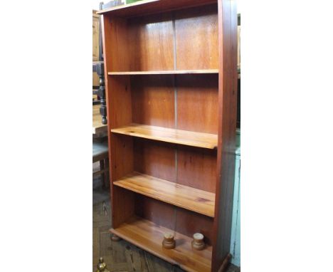 A green painted cupboard and open book shelf and a modern pine bookcase