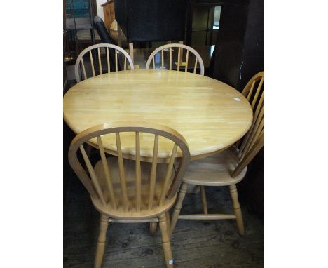 A modern circular beech breakfast table and four stick back chairs, diameter 40"