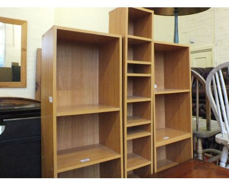 A modern Pine CD rack, two narrow bookcases and a cream pouffe