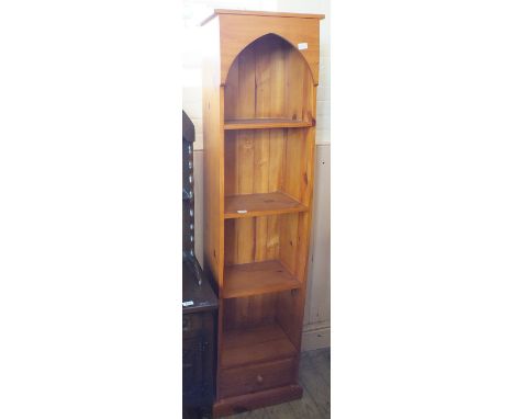 A modern pine narrow four shelf bookcase with single drawer below