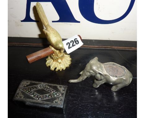 White metal elephant pin cushion, lacquered and inlaid snuff box and Mirella bird ring tree