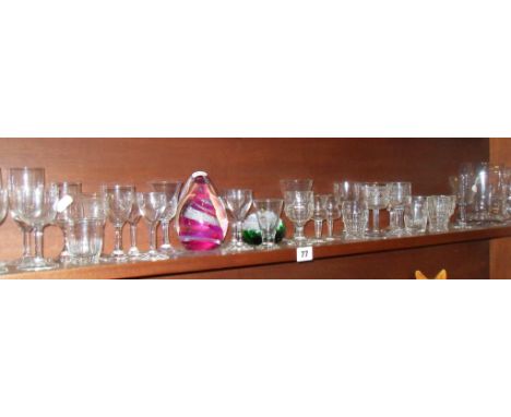 Shelf of glassware - drinking glasses and some paperweights