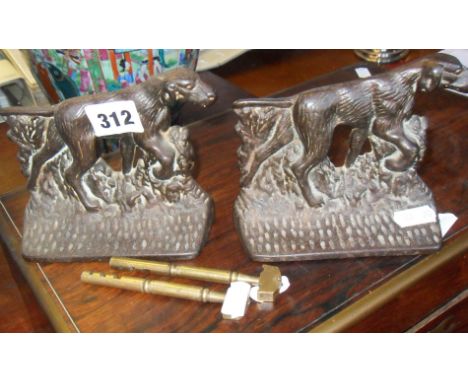 Two 19th c. cast iron shooting dogs bookends and two old brass glass cutting tools