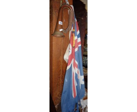 Old copper and brass bugle and a WW2 Australian naval flag (torn)