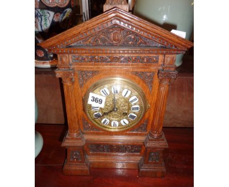 Victorian carved oak mantle clock with brass dial & enamel numerals