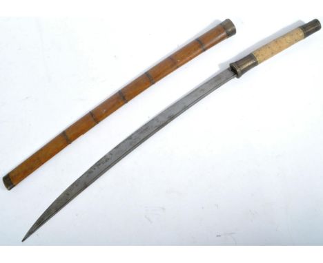 A 19th Century Burmese Dha sword. The sword having Stingray skin lined grip with brass collars. Th slightly curved single edg