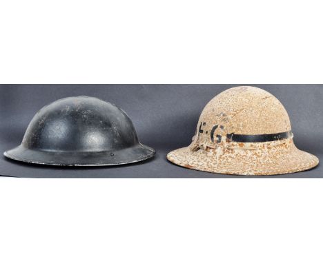 Two original WWII Second World War British Army steel combat helmets. The helmets comprising a 1939 dated brodie helmet with 