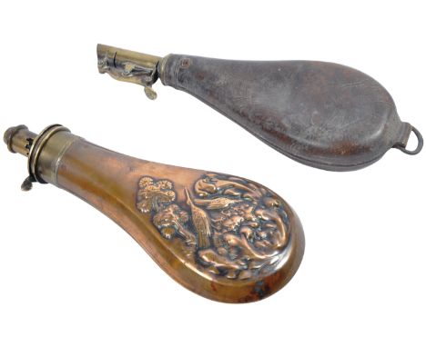 Two 19th century musket / rifle powder flasks. The first in copper and brass, the body featuring a naturalistic scene with tr