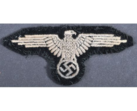 A WWII Second World War Third Reich Nazi German Waffen SS Officers uniform cloth patch. The badge depicting a white eagle clu