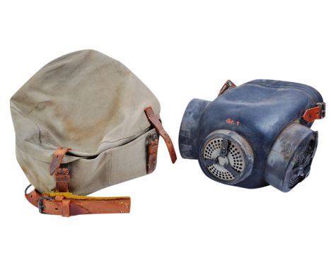 A rare WWII Second World War Third Reich Nazi German horse respirator gas mask. The mask having a large black rubber shield f