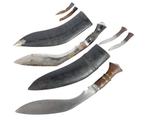 Two vintage 20th Century Gurkha Regiment Nepalese kukri knives / daggers. The first with wooden grips, with brass banding and