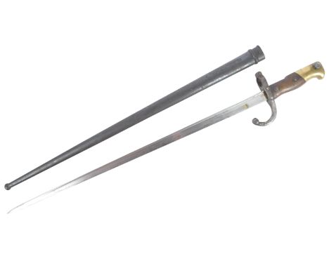 An original 19th Century French 1874 pattern Gras rifle bayonet. The hilt with brass pommel and wooden grips encasing the tan