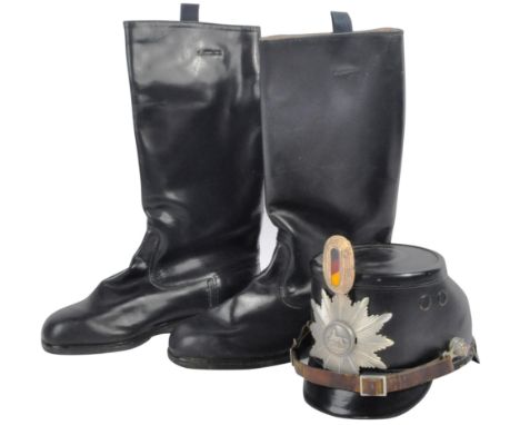 An original Cold War era circa 1950's West German Police shako helmet along with a pair of later period East German Army leat