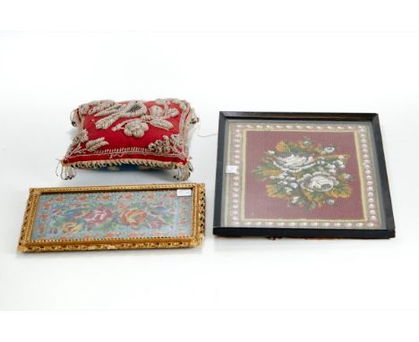 A LATE VICTORIAN RED FABRIC CUSHION with beadwork bird and flower designs, 23cms square, an ebonized framed BEADWORK PANEL, 2