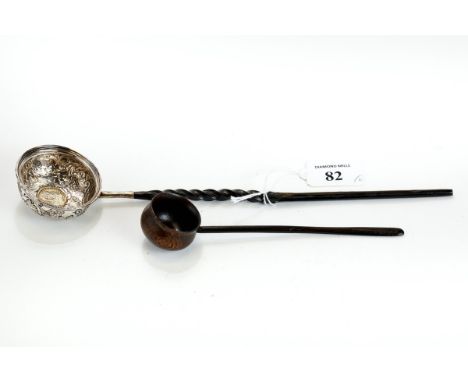 A GEORGE III WHITE METAL PUNCH/TODDY LADLE, the circular embossed bowl set with a 1757 Coin &amp; Whalebone handle, 30cm long