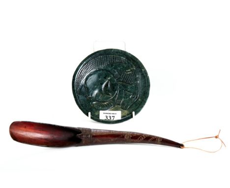 AN AMERICAN INDIAN GREENSTONE DISHED PLATE carved with a lizard and man's head, 6" diameter and a horn LADLE with incised dec