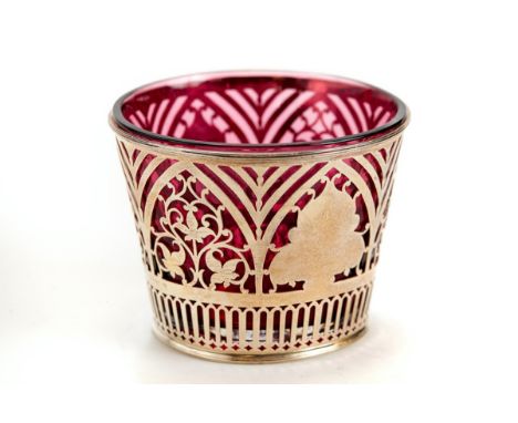 A LATE VICTORIAN PIERCED SILVER SUGAR BASIN of tapering cylindrical form, cranberry liner, maker: GN.RN, Chester 1898, approx