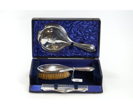 AN EDWARDIAN SILVER THREE-PIECE DRESSING TABLE SET comprising: Hand Mirror, Hair Brush, Birmingham 1910 &amp; associated silv