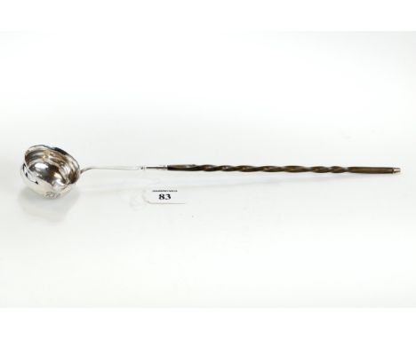A GEORGE III WHITE METAL PUNCH/TODDY LADLE, the circular lipped bowl fitted with a twisted baleen handle, 38 cms long. £40-£6