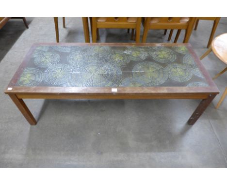 A teak and ceramic abstract top coffee table