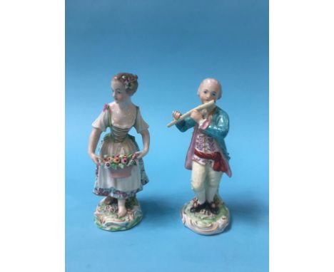 A pair of Derby figures of a lady holding a basket of flowers, with flowers in her hair and a young man playing a flute, both