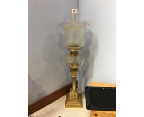 A brass Corinthian column oil lamp, with etched glass shade and reservoir