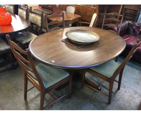 An Ercol oval dining table and four ladderback chairs