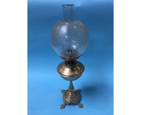A brass oil lamp, with etched glass shade