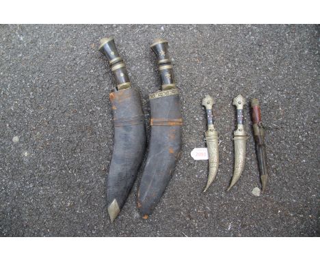 Two kukris; together with two small jambiya; and a small Norwegian hunting knife. (5)