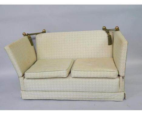 A Knowle two seater sofa, upholstered in a green repeating floral pattern fabric, 137cm long.