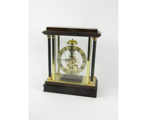 A wooden and brass cased skeleton clock, of architectural form, brass chapter ring bearing Roman numerals, battery operated, 