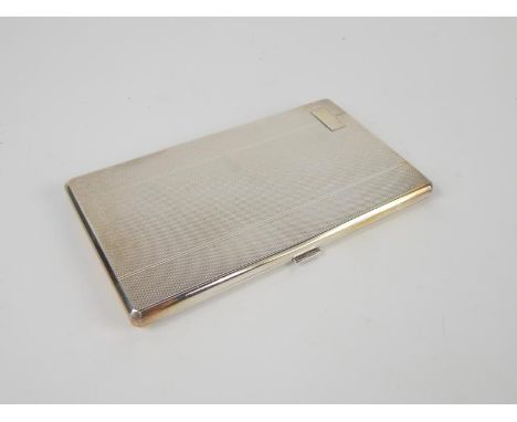 A George VI silver cigarette case, with engine turned decoration, containing cigarettes and cards, Birmingham 1945, 8.06oz al