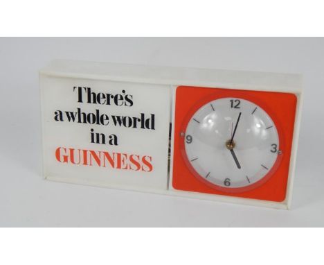 A Guinness plastic and perspex cased electric mantel clock, rectangular case, circular dial bearing Arabic numerals at quarte