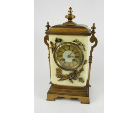A French early 20thC burnished brass and pottery mantel clock, circular white dial with gilt chapter ring bearing Roman numer